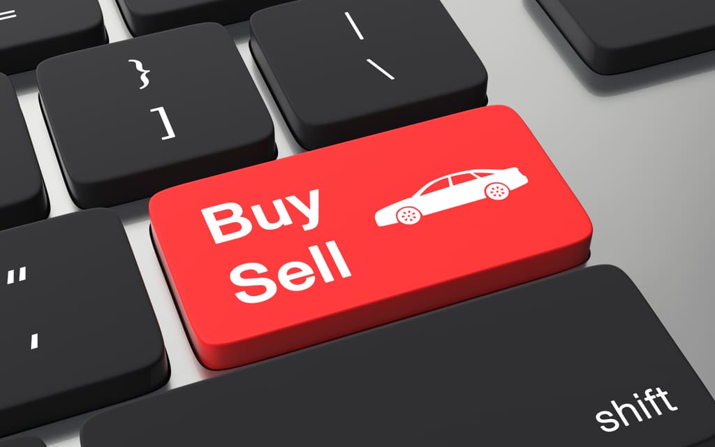 Online car buying and selling represented by a buy-sell button on a keyboard